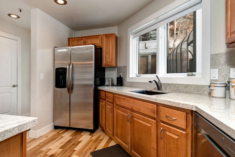 Kitchen: Sleek refrigerator and spacious countertop