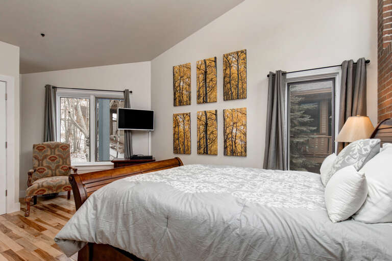 Sink into crisp linens and wake to natural light streaming through your windows. Enjoy woodland views, a cozy reading nook, and modern entertainment—your perfect retreat awaits.