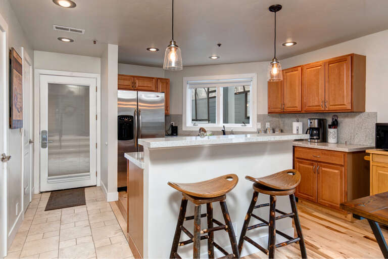 Prepare your favorite meals in this inviting open kitchen with stainless steel appliances, granite countertops, and a breakfast bar perfect for morning coffee or casual dining.