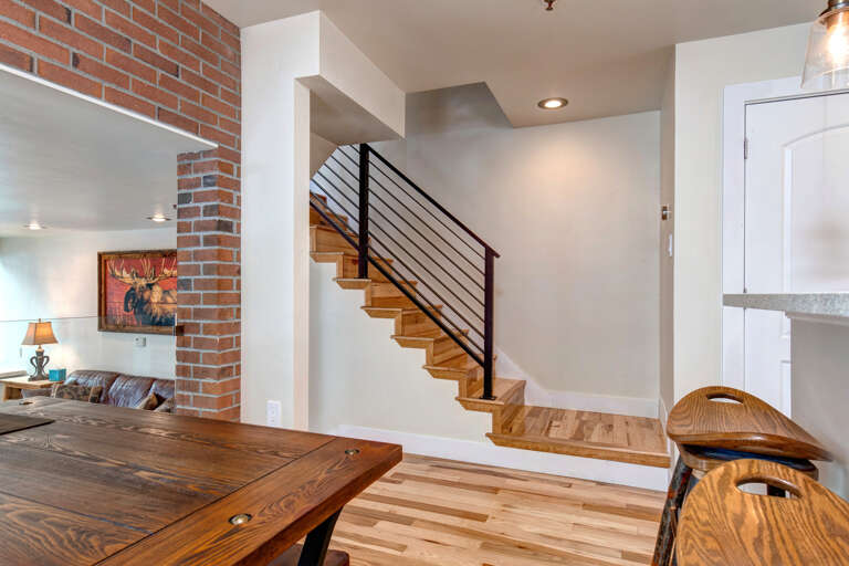 Step into your stylish retreat featuring warm wood floors, exposed brick accents, and modern details. Natural light flows through the open space, creating a welcoming atmosphere.