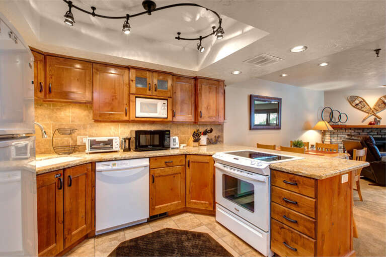Modern appliances and warm wood accents in this cozy cooking space.