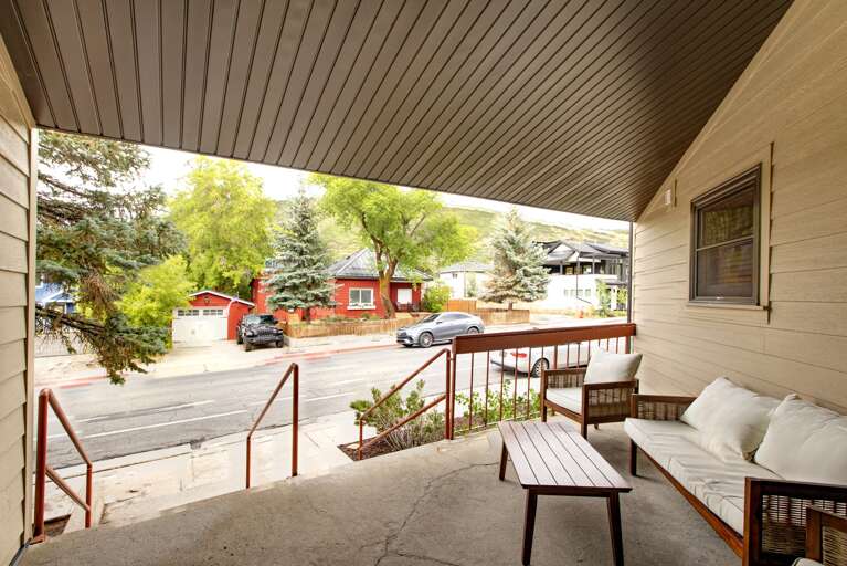 The property sits on a quiet residential street with mountain views and charming neighborhood character, offering a peaceful retreat surrounded by mature trees and convenient street access.