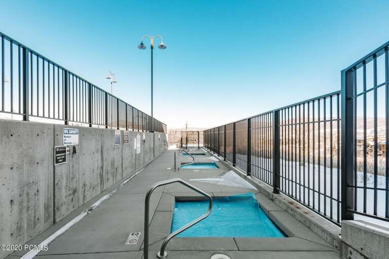 A rooftop pool area with mountain views offers a refreshing retreat under open skies.