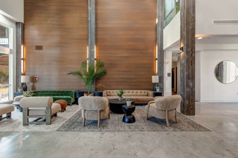 Stylish lobby welcomes you with warm wood accents, cozy seating, and natural light—a modern space designed for your comfort and relaxation.