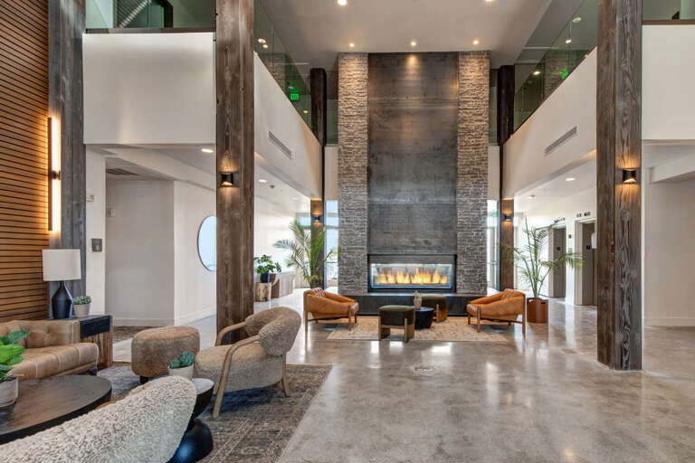 Step into a stunning lobby where soaring ceilings, rustic wood beams, and a dramatic stone fireplace create an inviting first impression for your arrival.