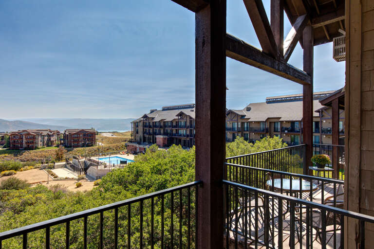 This elevated balcony offers panoramic views of the resort community and surrounding natural landscape, providing a perfect vantage point to appreciate the property's peaceful lakeside setting.