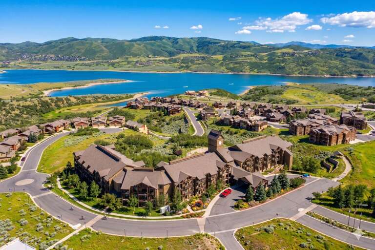 Lakeside property nestled in a scenic mountain valley with pristine waters and rolling hills, offering a peaceful retreat in a naturally beautiful setting.