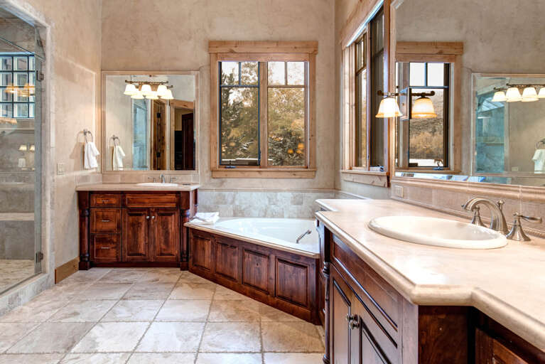 Bathroom: "Luxurious bathtub and elegant sinks create a spa-like retreat."