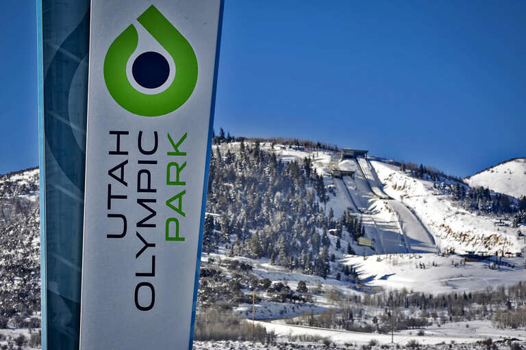 The property stands near Utah Olympic Park, a renowned winter sports venue featuring ski jumps and mountain terrain, visible from the surrounding area.