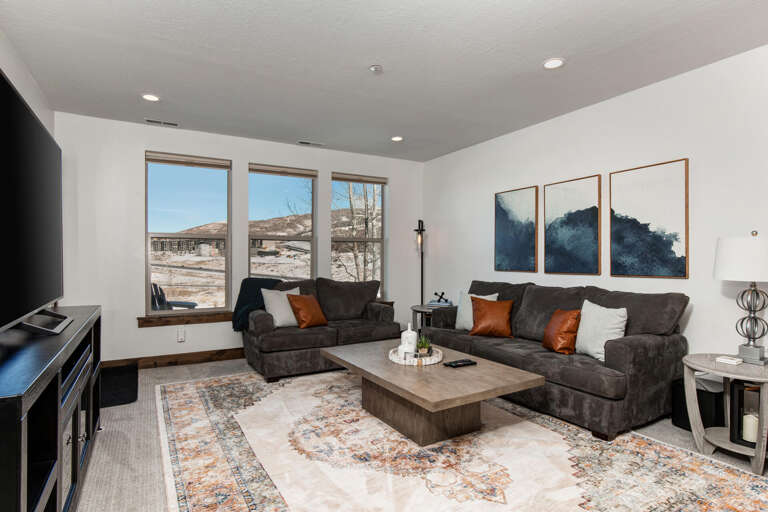 Sink into plush sofas and enjoy desert vistas through expansive windows. This airy living room blends modern comfort with natural beauty—your perfect retreat.