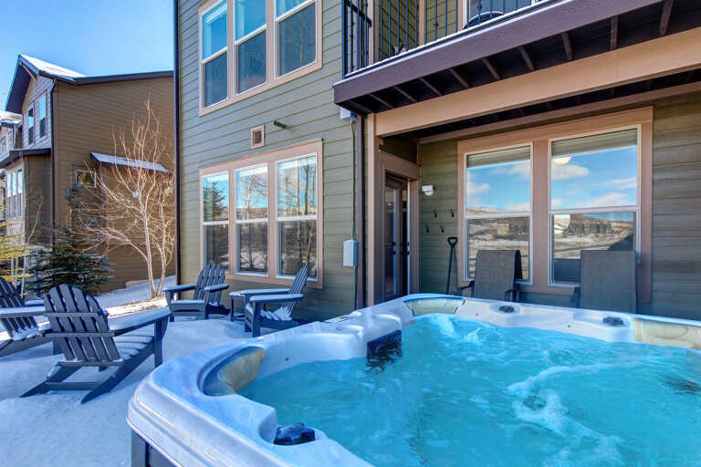 Imagine soaking in this steaming hot tub under a crisp blue sky, surrounded by mountain views and fresh alpine air—your perfect winter retreat awaits.