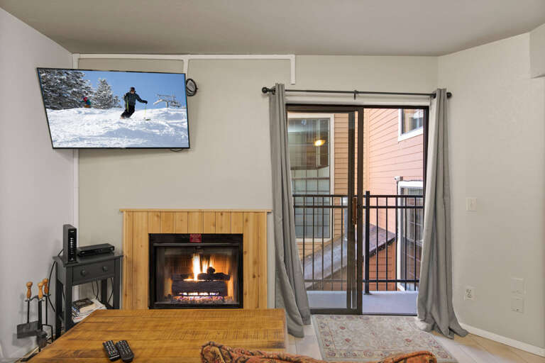 Cozy ambiance with a fireplace and balcony view from the sofa. Cozy ambiance with a fireplace and balcony view from the sofa.