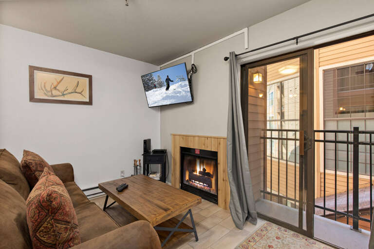 Cozy ambiance with a fireplace and balcony view from the sofa. Cozy ambiance with a fireplace and balcony view from the sofa.