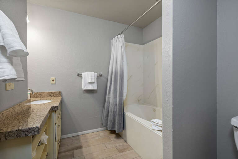 Relaxing tub shower combo in a spacious full bathroom. Relaxing tub shower combo in a spacious full bathroom.