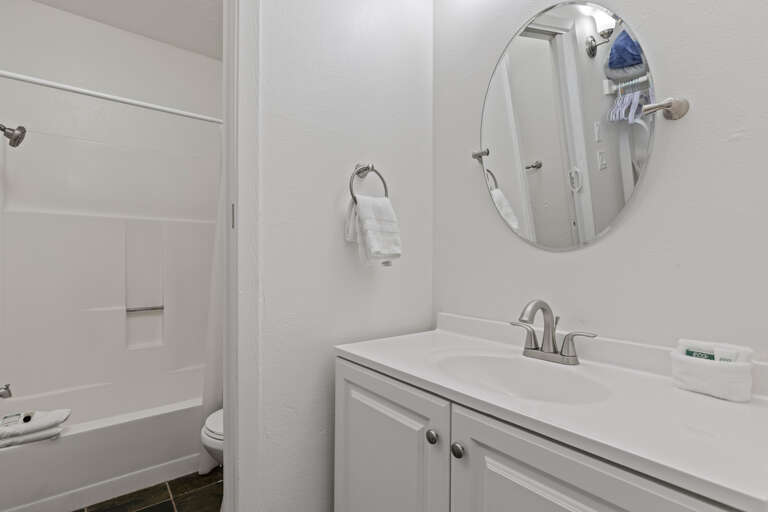 Reflective sink area with a sleek mirror, perfect for morning routines.