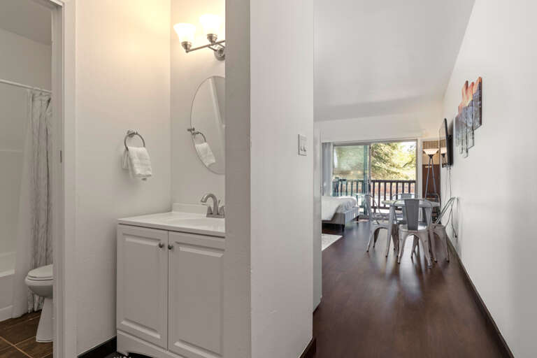 Reflective sink area with a sleek mirror, perfect for morning routines. Reflective sink area with a sleek mirror, perfect for morning routines.