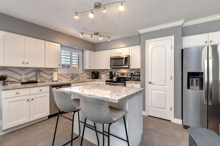 Cozy bar stools by the kitchen bar table, perfect for breakfast.