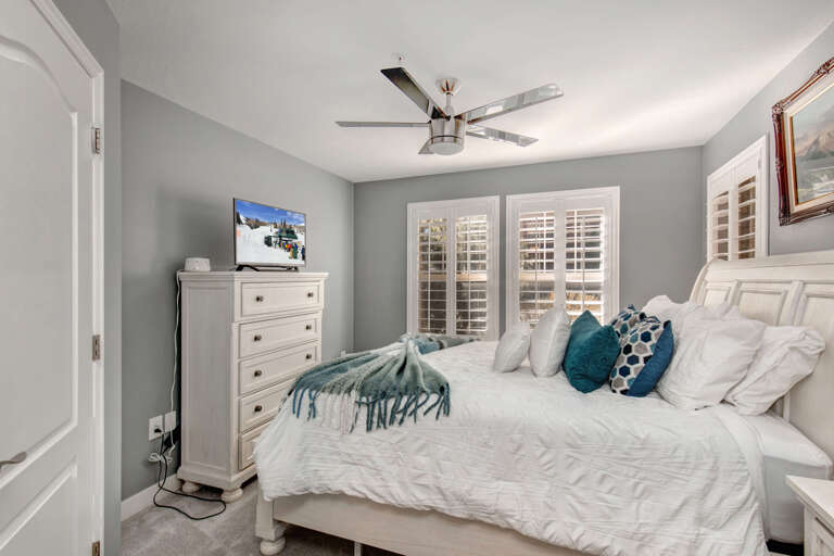 Cozy bed by the windows, perfect for a peaceful night's sleep.