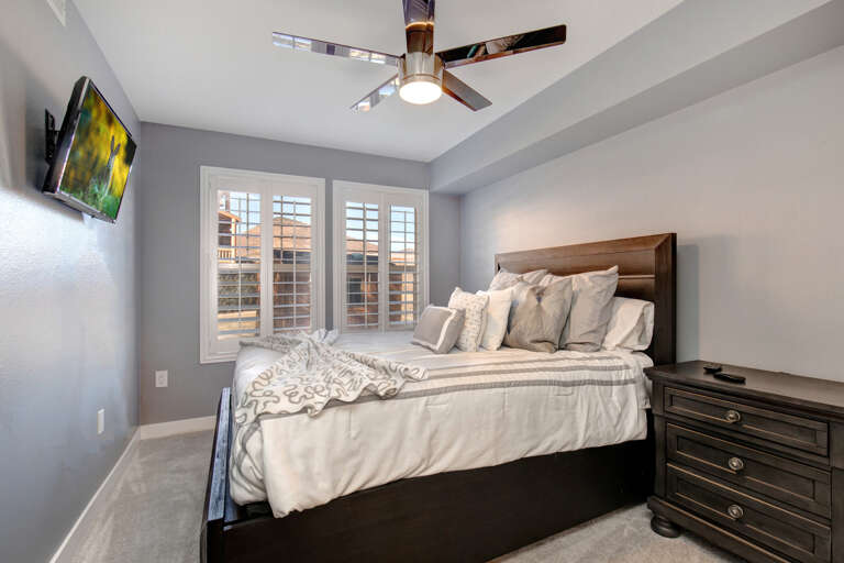 Cozy bed by the windows, perfect for a peaceful night's sleep.