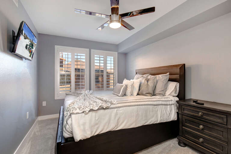 Cozy bed by the windows, perfect for a peaceful night's sleep.