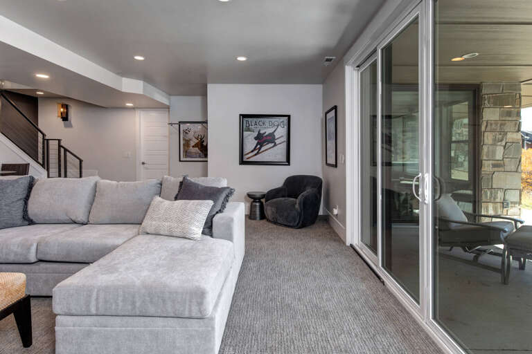 Unwind in your spacious living area with plush seating, cozy décor, and glass doors opening to your private outdoor retreat.