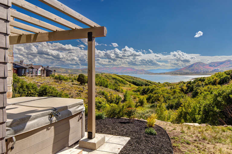 Unwind in your private hot tub while soaking in sweeping lake and mountain vistas—a perfect retreat after a day of exploring the area's natural beauty.