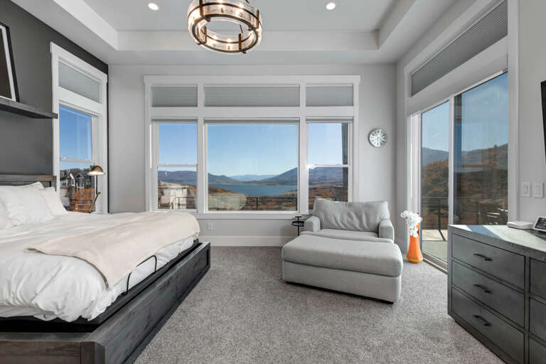 Wake up to breathtaking mountain and lake vistas framed by floor-to-ceiling windows. Your serene retreat features plush bedding, stylish furnishings, and peaceful views that make every morning unforgettable.