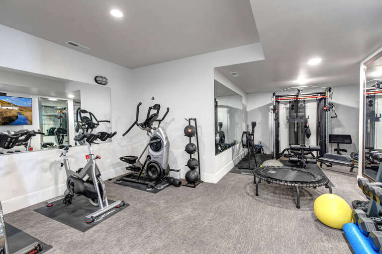 Your private fitness center features cardio equipment, strength training stations, and a mini trampoline—everything you need for an energizing workout without leaving home.