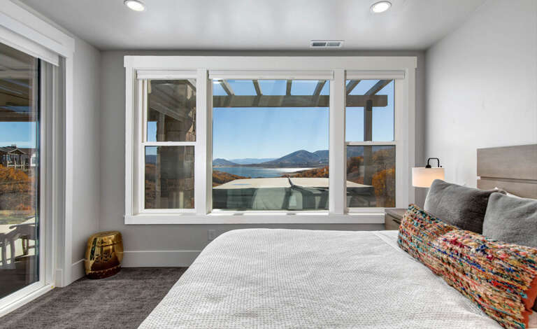 Wake up to sweeping mountain and lake vistas from your bed. Bright, airy space with modern touches and direct balcony access—your peaceful retreat awaits.