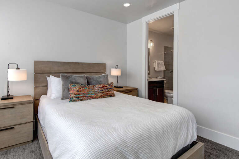 Sink into crisp linens and plush pillows after a day of adventure. Your private ensuite bathroom awaits just steps away for ultimate convenience.