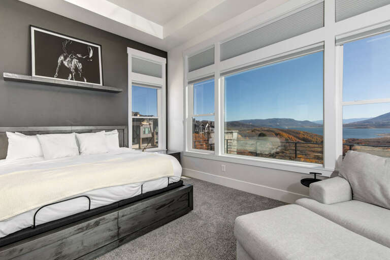 Wake up to sweeping mountain and lake views through expansive windows. Sink into the plush king bed and unwind in your stylish seating area after a day exploring.