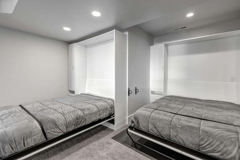Rest easy in this clever space featuring two Murphy beds that maximize your room while maintaining comfort and style for a perfect night's sleep.