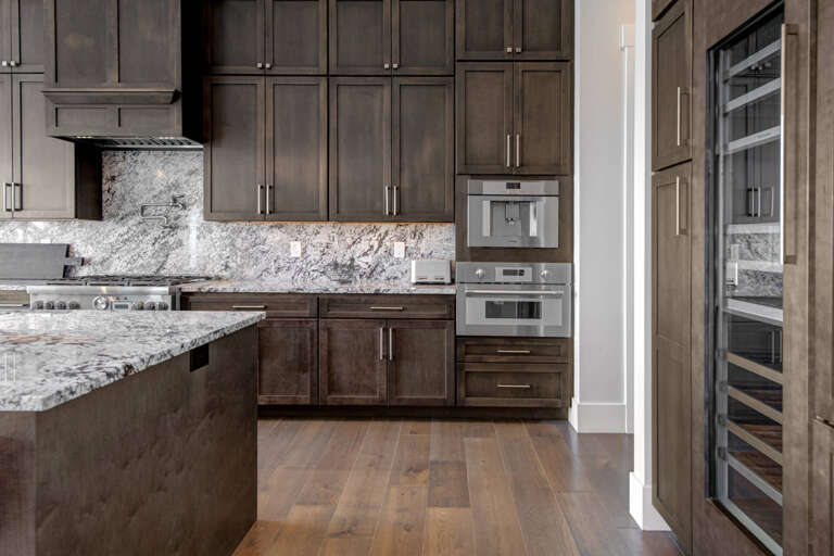 Your gourmet kitchen boasts gleaming marble countertops, a professional-grade gas range, and rich wood cabinetry that invites you to cook, entertain, and savor every moment of your stay.