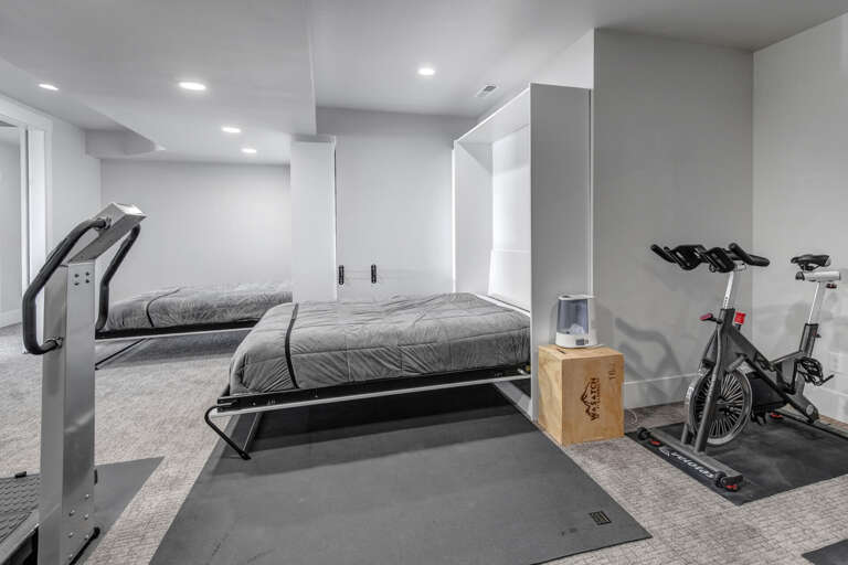 Your multi-purpose space combines restful sleep with fitness convenience—two Murphy beds fold down for flexible sleeping arrangements, while a stationary bike and equipment let you keep up your workout routine during your stay.