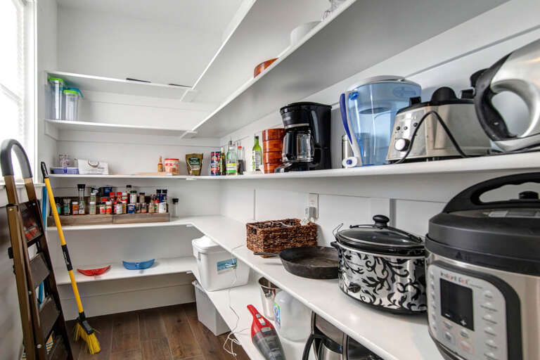 Fully stocked pantry with your cooking essentials at your fingertips—coffee maker, water filter, slow cookers, and spices ready for you to whip up your favorite meals.