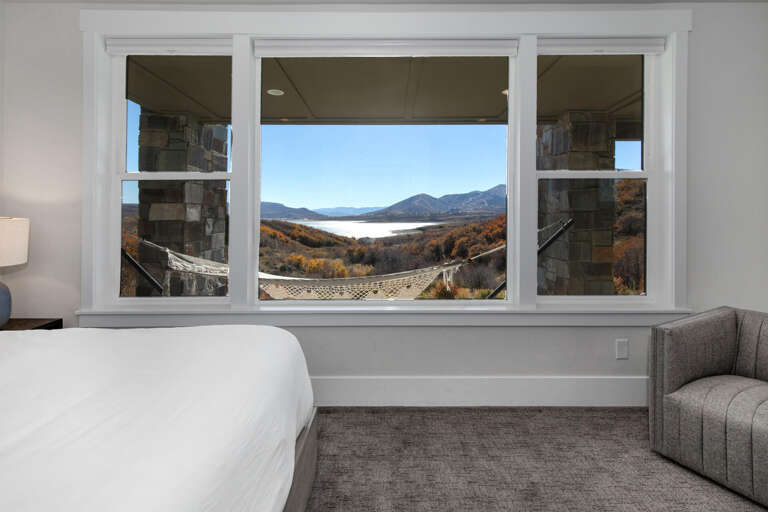 Wake up to stunning mountain and lake views framed by your bedroom window. Your cozy retreat offers plush bedding, modern seating, and a peaceful atmosphere perfect for unwinding after a day of adventure.