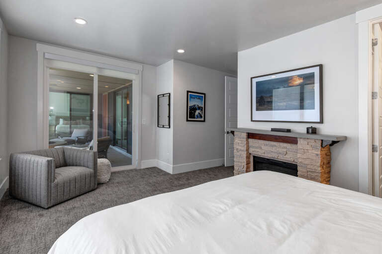 Settle into your serene bedroom suite, where a cozy fireplace and private balcony access create the perfect retreat for peaceful mornings and restful evenings.