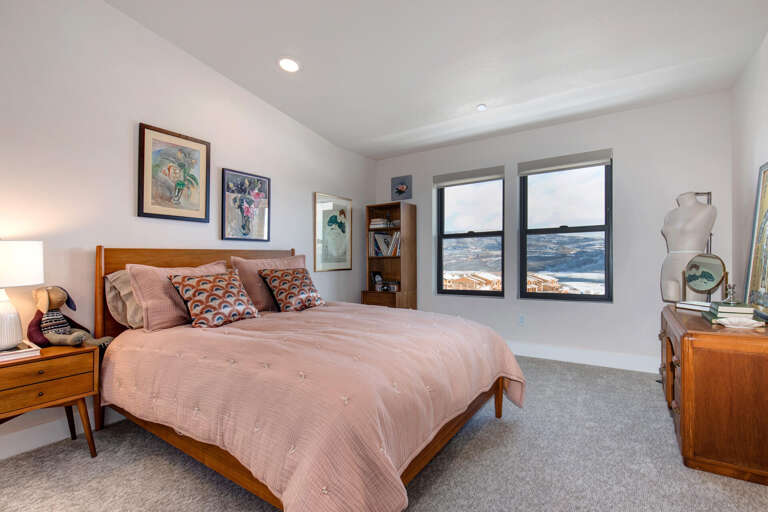 Sunlight streams through windows onto the cozy bed. Sunlight streams through windows onto the cozy bed.