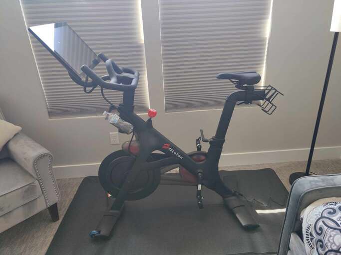 Keep up with your fitness routine on the stationary bike in this comfortable in-home workout space, complete with natural lighting to energize your mornings.