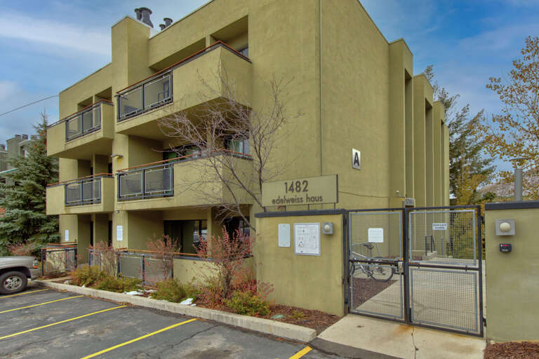 Modern vacation rental building with distinctive architecture, featuring private balconies and secure entrance access in a peaceful residential setting.