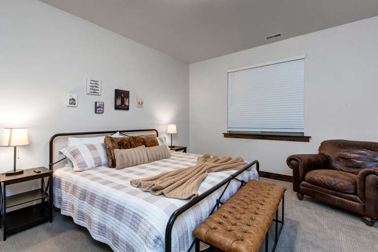 Sink into the plush bed and unwind in your cozy retreat, where soft linens and warm earth tones create a restful sanctuary after your adventures.