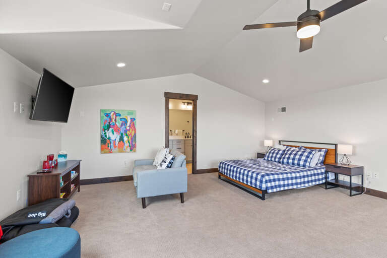 Stretch out in your spacious bedroom featuring vaulted ceilings, a cozy sitting area, and a private ensuite. The bright, modern design and comfortable bedding ensure you'll wake up refreshed every morning.