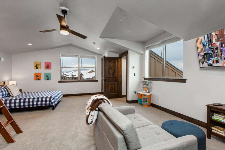 This bright, spacious room offers your family the best of both worlds—cozy sleeping space, room to play, and stunning mountain views from the window. A perfect retreat for everyone.