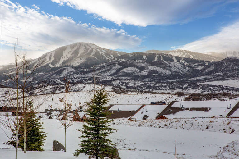 Stunning mountain vistas and ski slopes frame this winter retreat, offering pristine surroundings and quick access to outdoor adventure in a serene alpine neighborhood.
