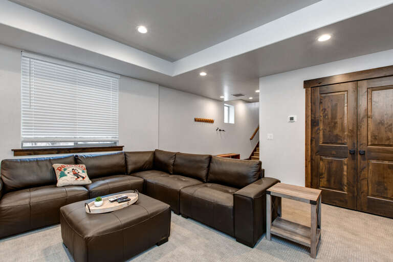 Sink into this plush sectional and unwind in your private lower-level retreat. Rustic wood doors add character, while modern finishes create a cozy space to relax after a day exploring.
