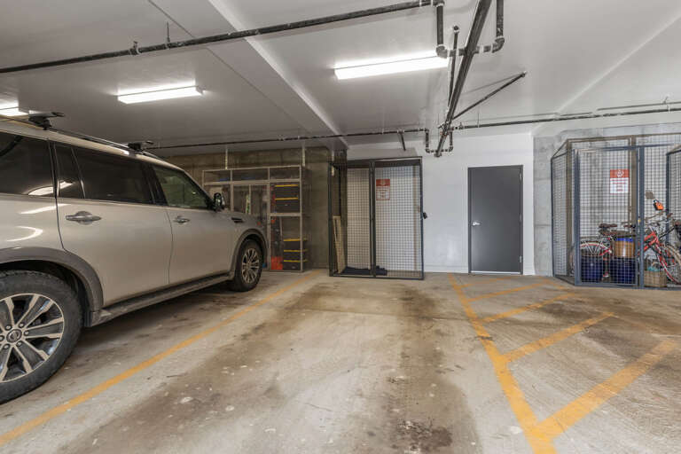 Secure underground parking garage with designated spaces, storage cages, and bike racks for your convenience during your stay.