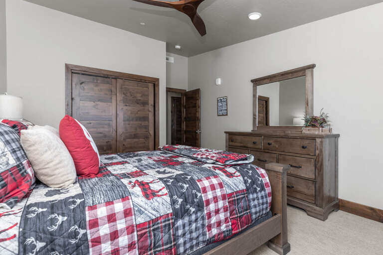 Sink into the plush bed after a long day, surrounded by rustic wood tones and vaulted ceilings. Your cozy retreat features warm bedding, ample storage, and space to unwind in comfort.