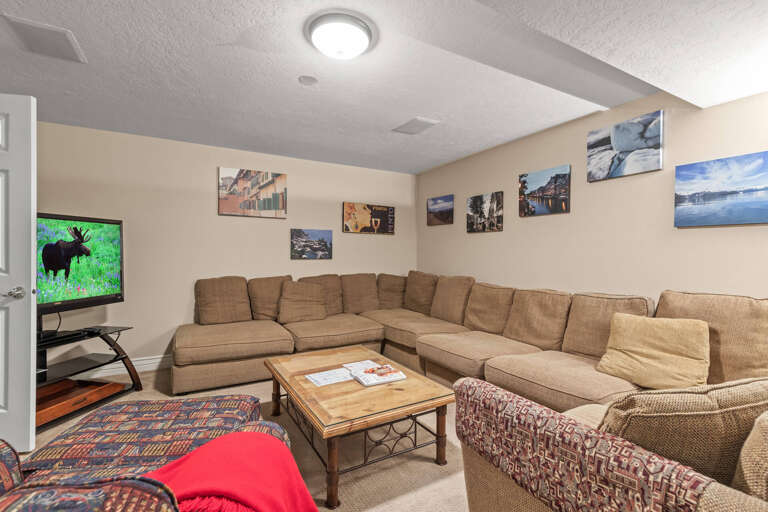 Cozy setup with a stylish sofa set and entertainment center.