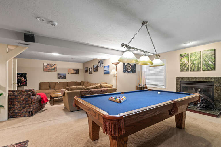 Cozy space with mini kitchen, pool table, and comfortable set.