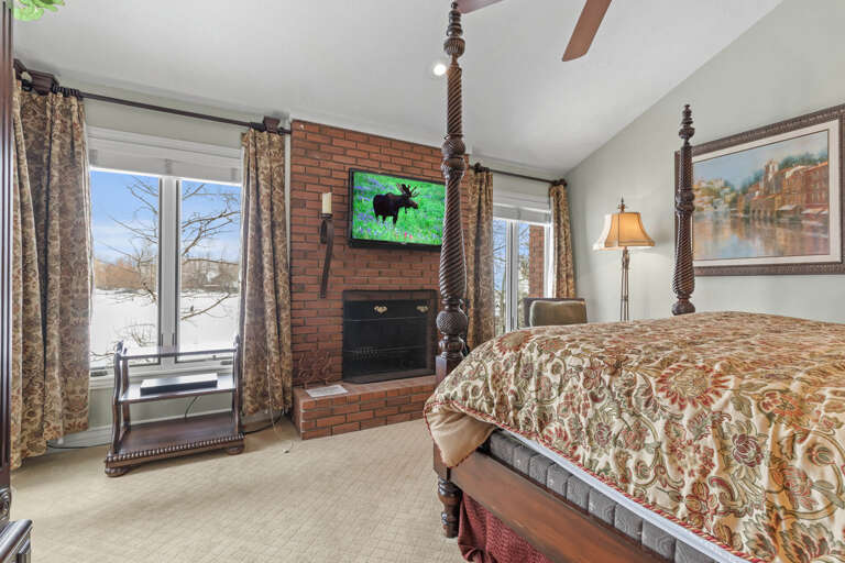 Master Bedroom: "Cozy retreat with fireplace, king bed, and natural light streaming in."
